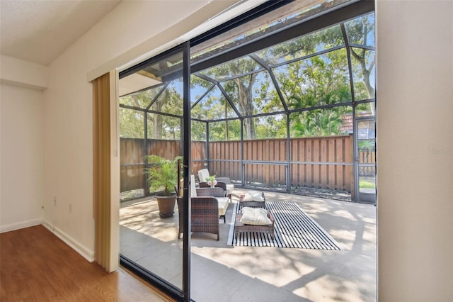 doorway to outside with hardwood / wood-style floors and plenty of natural light