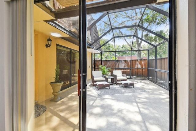 view of patio featuring glass enclosure