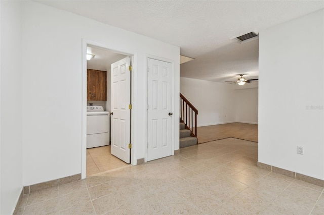 empty room featuring washer / clothes dryer, a textured ceiling, and ceiling fan