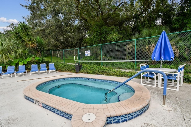 view of pool with a community hot tub and a patio area