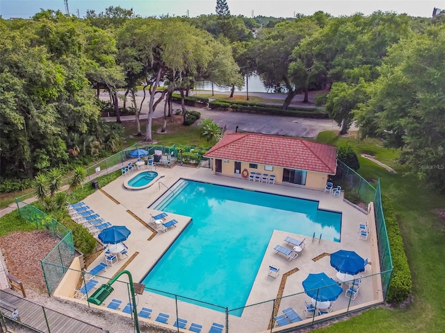 view of pool with a patio area and a lawn