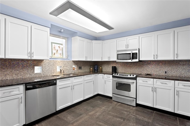 kitchen with white cabinets, decorative backsplash, sink, and stainless steel appliances