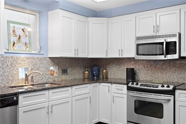 kitchen featuring white cabinets, decorative backsplash, sink, and stainless steel appliances