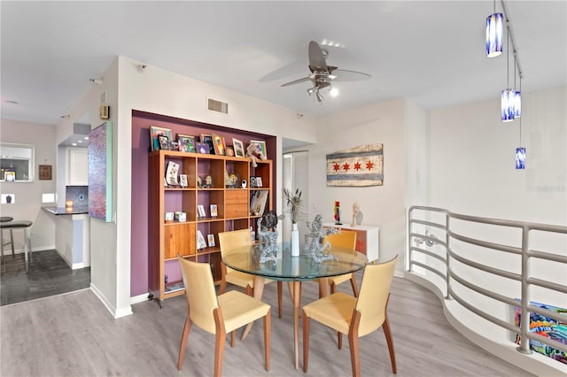 dining area featuring hardwood / wood-style flooring and ceiling fan