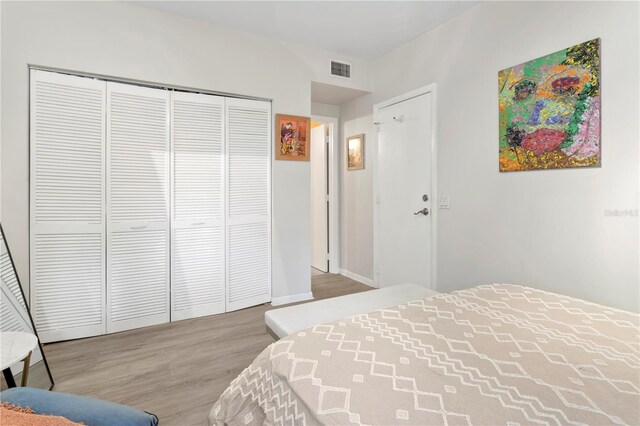 bedroom with a closet and hardwood / wood-style floors