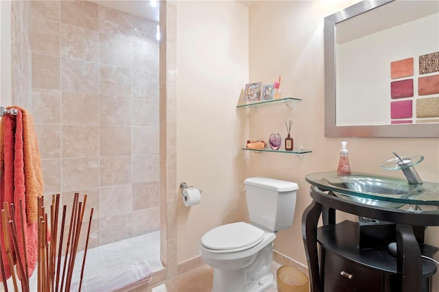 bathroom with toilet and tiled shower