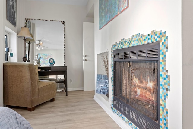 living room featuring ceiling fan and light wood-type flooring