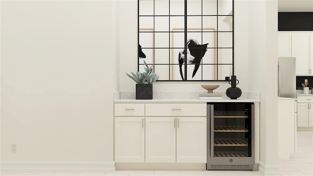 bar featuring white cabinets and wine cooler