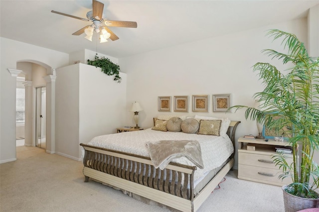 carpeted bedroom with ornate columns and ceiling fan