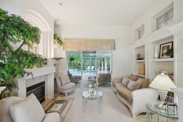 carpeted living room featuring a fireplace