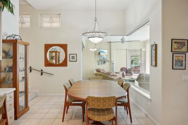 tiled dining space featuring ceiling fan