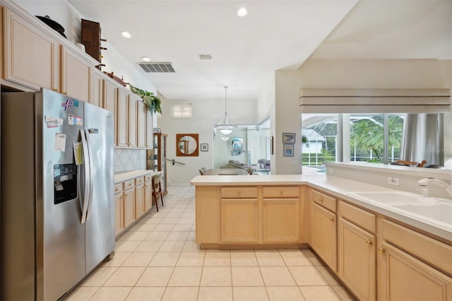 kitchen featuring sink, kitchen peninsula, stainless steel fridge with ice dispenser, and light brown cabinets