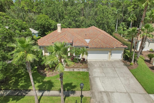 view of front of property with a garage and a front lawn