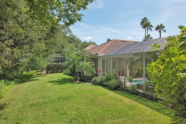 view of yard featuring glass enclosure