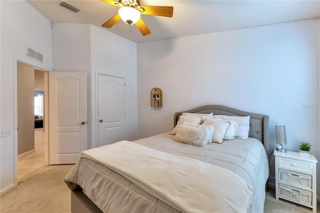 carpeted bedroom with a towering ceiling and ceiling fan