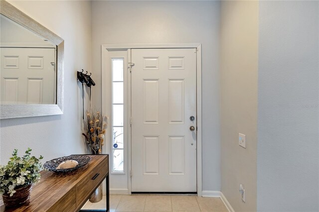 foyer with light tile patterned floors and a healthy amount of sunlight