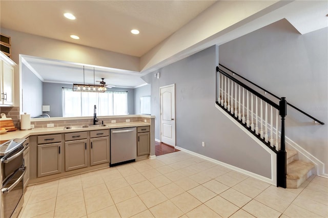 kitchen with ceiling fan, pendant lighting, sink, backsplash, and stainless steel appliances