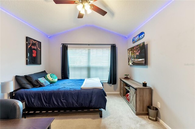 bedroom with lofted ceiling, ceiling fan, and light colored carpet