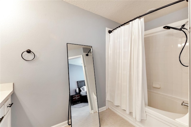 bathroom featuring a textured ceiling, shower / tub combo, tile patterned flooring, and vanity