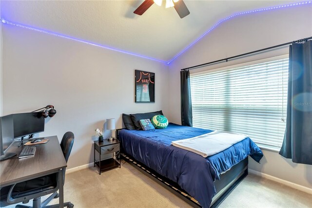 bedroom featuring ceiling fan, light carpet, and vaulted ceiling