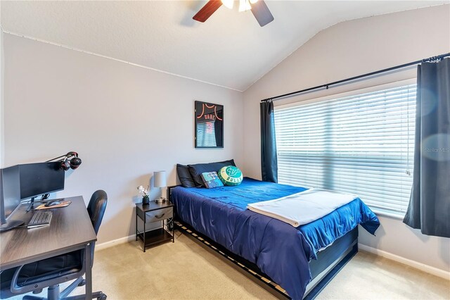 bedroom featuring ceiling fan, light colored carpet, and vaulted ceiling