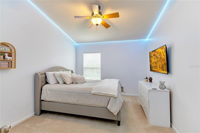 bedroom featuring vaulted ceiling, light carpet, and ceiling fan