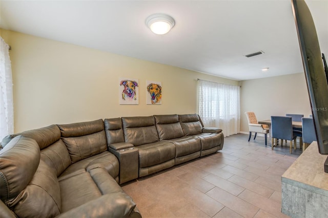 living room with light tile patterned floors and visible vents