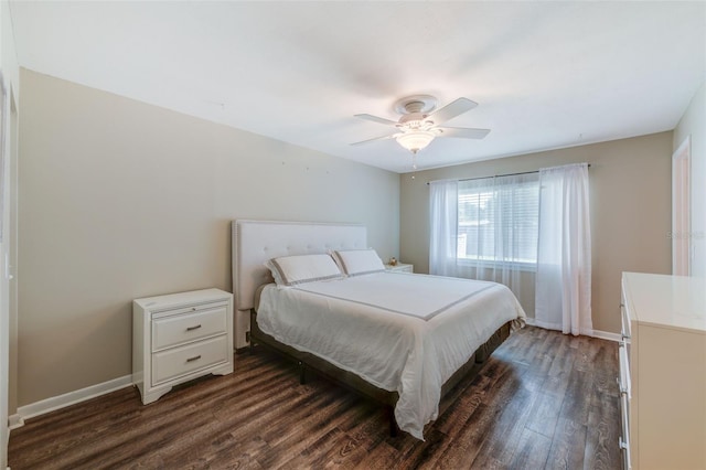 bedroom with baseboards, dark wood finished floors, and a ceiling fan