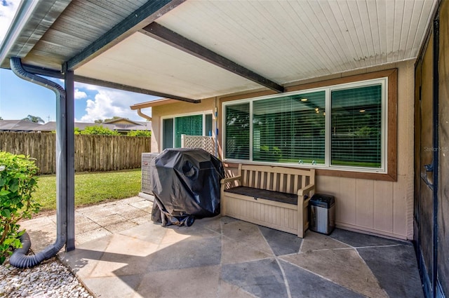 view of patio / terrace featuring a grill and fence