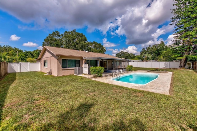 view of swimming pool featuring a fenced backyard, a sunroom, a yard, a fenced in pool, and a patio area