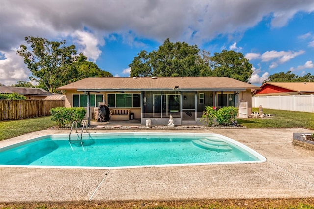 back of property with a patio, a lawn, a fenced backyard, and a sunroom