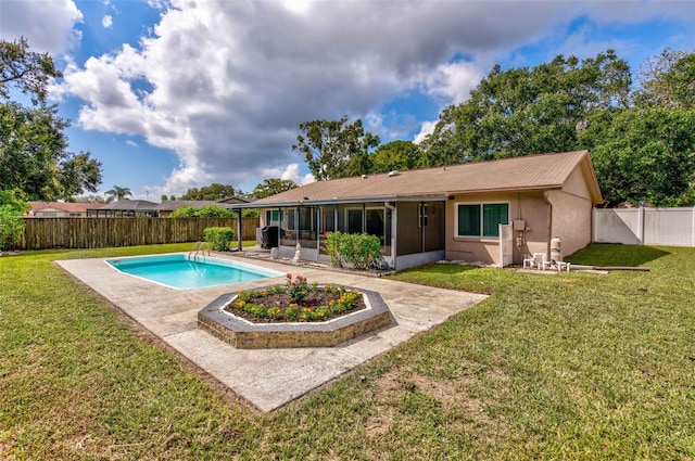 view of swimming pool with a fenced in pool, a lawn, a sunroom, a patio area, and a fenced backyard