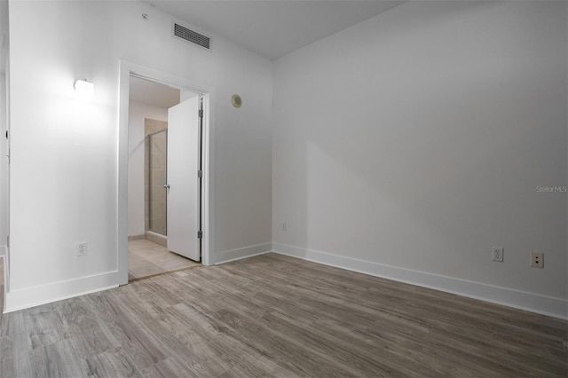 unfurnished room with light wood-type flooring