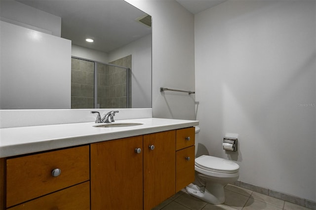 bathroom with tile patterned floors, walk in shower, vanity, and toilet