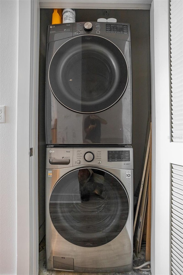 laundry room with stacked washer and clothes dryer