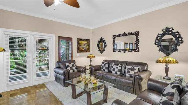 living room with ornamental molding and ceiling fan