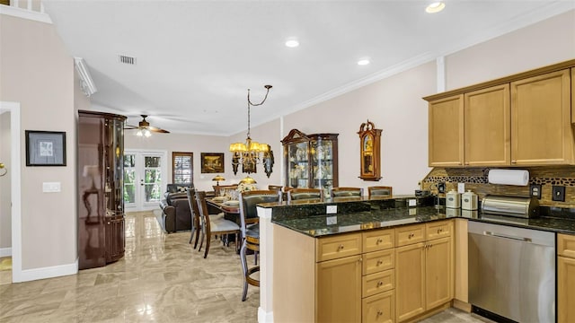 kitchen featuring decorative backsplash, ceiling fan with notable chandelier, dishwasher, crown molding, and dark stone counters