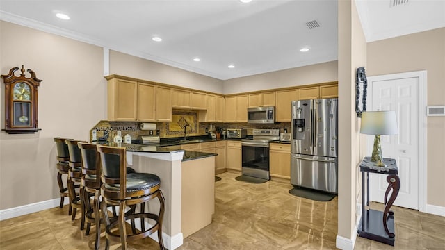 kitchen with decorative backsplash, kitchen peninsula, appliances with stainless steel finishes, and sink