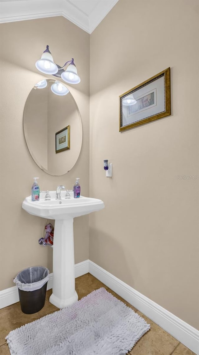 bathroom with tile patterned flooring, vaulted ceiling, and crown molding