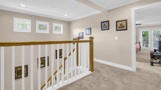 hall with crown molding and light colored carpet