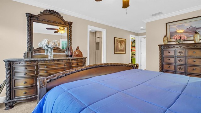 carpeted bedroom with ceiling fan and crown molding