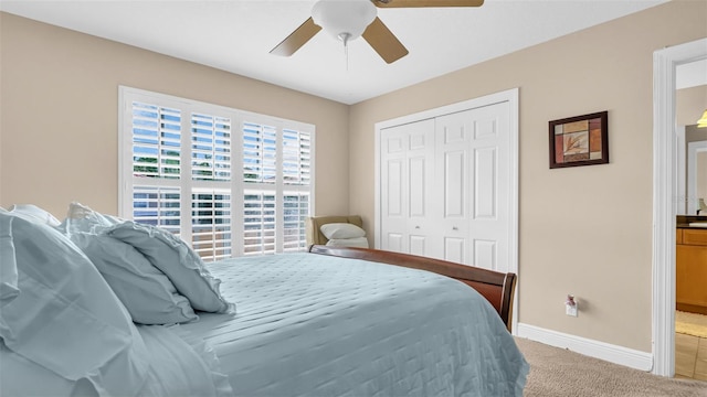 bedroom with a closet, ceiling fan, and carpet flooring