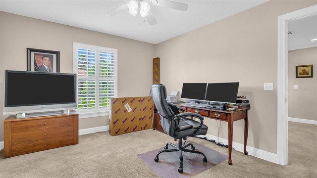 carpeted office featuring ceiling fan