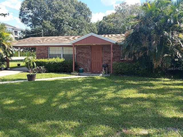 view of front of property with a carport and a front lawn