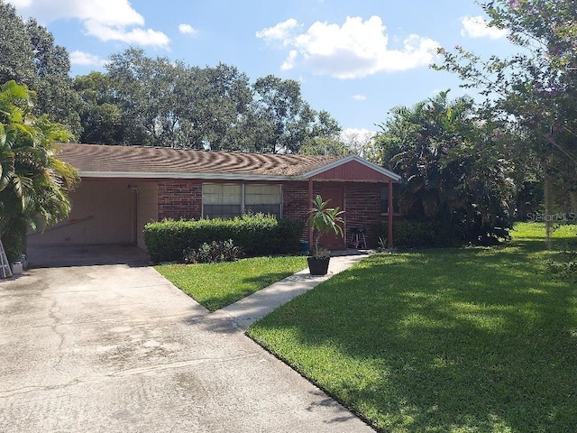 ranch-style house with a carport and a front lawn