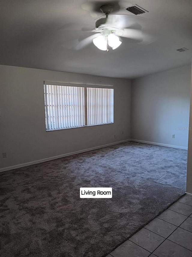 carpeted spare room with ceiling fan