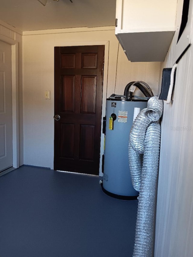 utility room featuring water heater