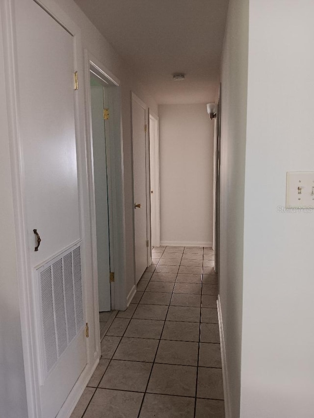 hallway with tile patterned floors