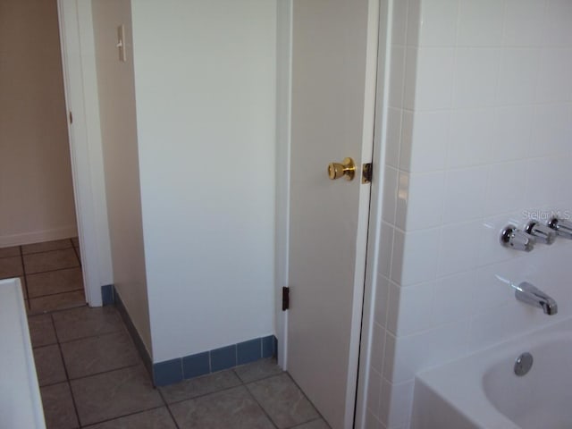 bathroom featuring tile patterned flooring and shower / bathing tub combination