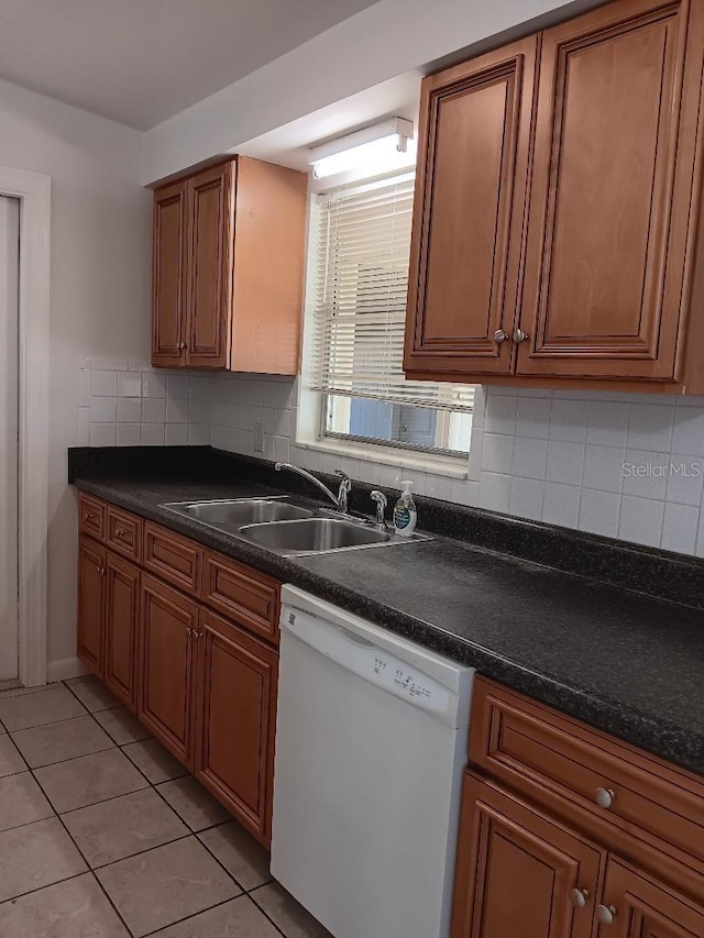 kitchen with white dishwasher, sink, decorative backsplash, and light tile patterned flooring